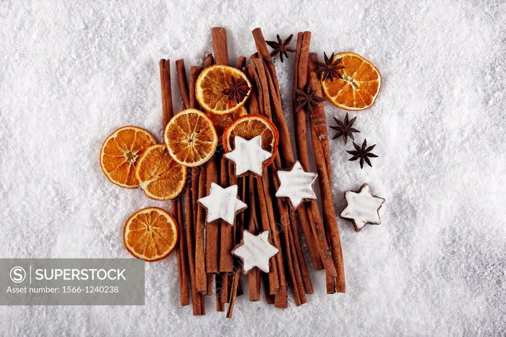 fruits of star anise - Illicium verum - cinnamon sticks - Cinnamomum cassia - dried orange slices - cinnamon star cookies at christmas - artificial sn...