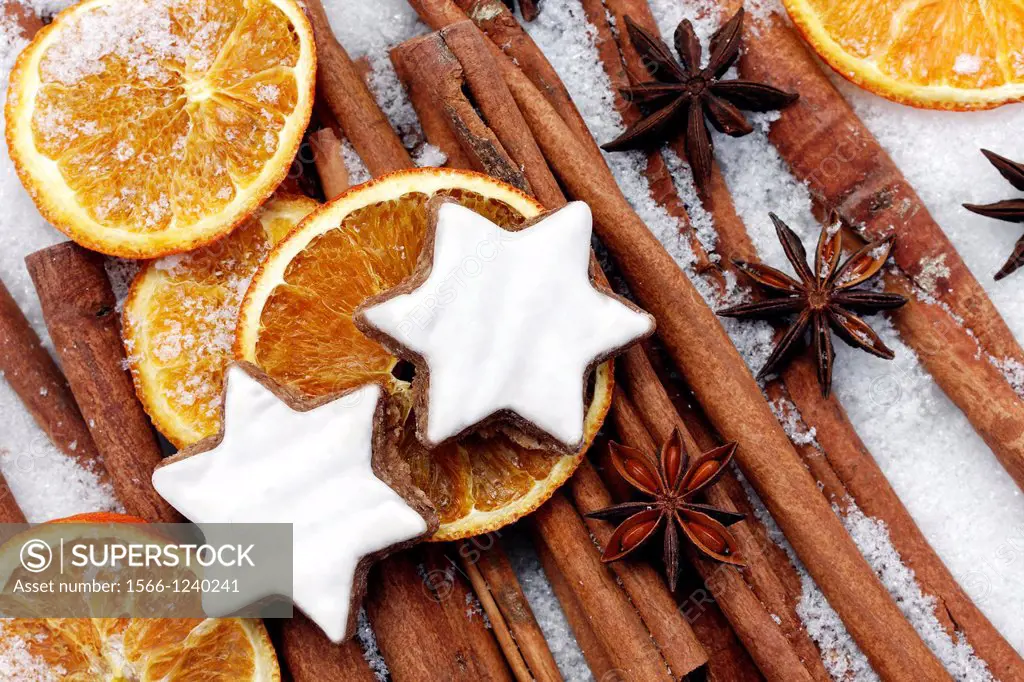 fruits of star anise - Illicium verum - cinnamon sticks - Cinnamomum cassia - dried orange slices - cinnamon star cookies at christmas - artificial sn...