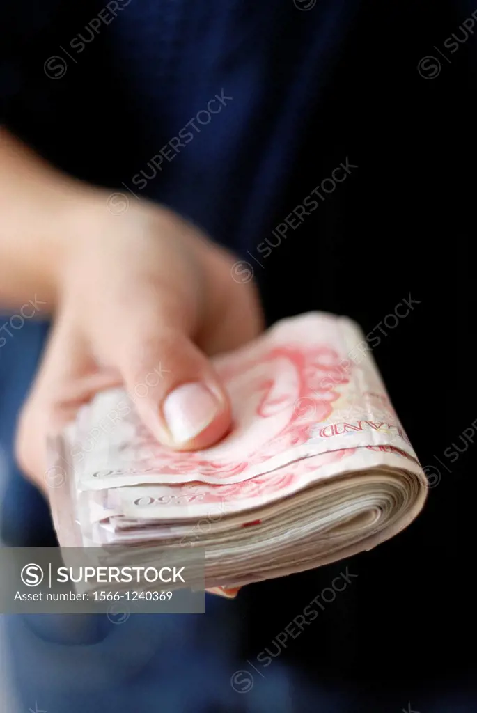 Person handing cash- UK Pound Sterling