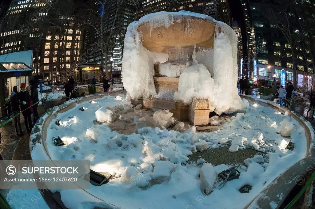Visitors to Bryant Park in New York stop at the Josephine Shaw Lowell Memorial Fountain which has become a cold weather ice sculpture. As the fountain...