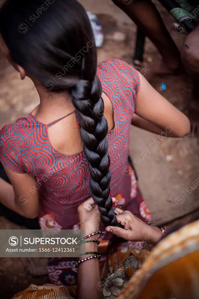 Women making a braid on the street