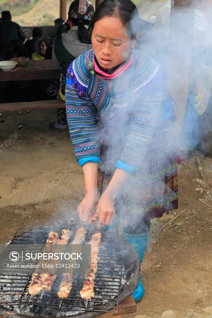 Vietnam, Lao Cai Province, Can Cau, market, hill tribes people, woman grilling meat,.