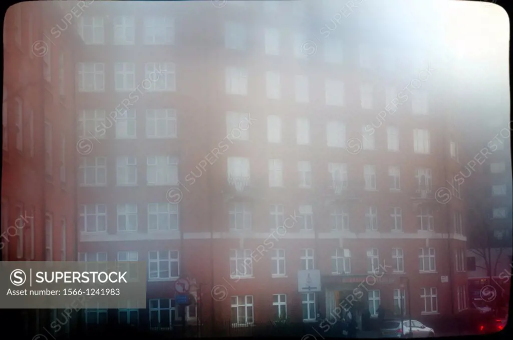 clasic urban architecture of a building of flats in the city of London, England, UK, with fog