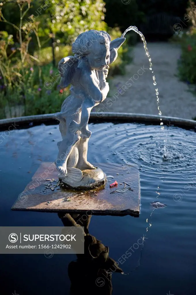 Fountain statue of Eros in the Collector Earl´s Gardens at Arundel Castle, photographed late afternoon, West Sussex, UK