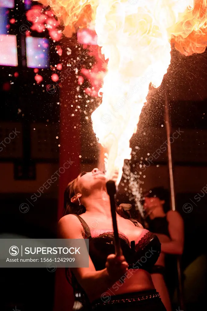 Female Performer from the Fuel Girls Fire Breathing on Stage at Tobacco Dock in Shadwell  London UK