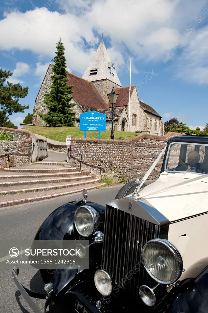 Vintage wedding car waiting outside St Margarets Church in Ditchling, Sussex