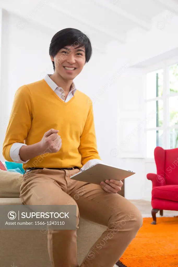 Young Asian man using his Tablet computer