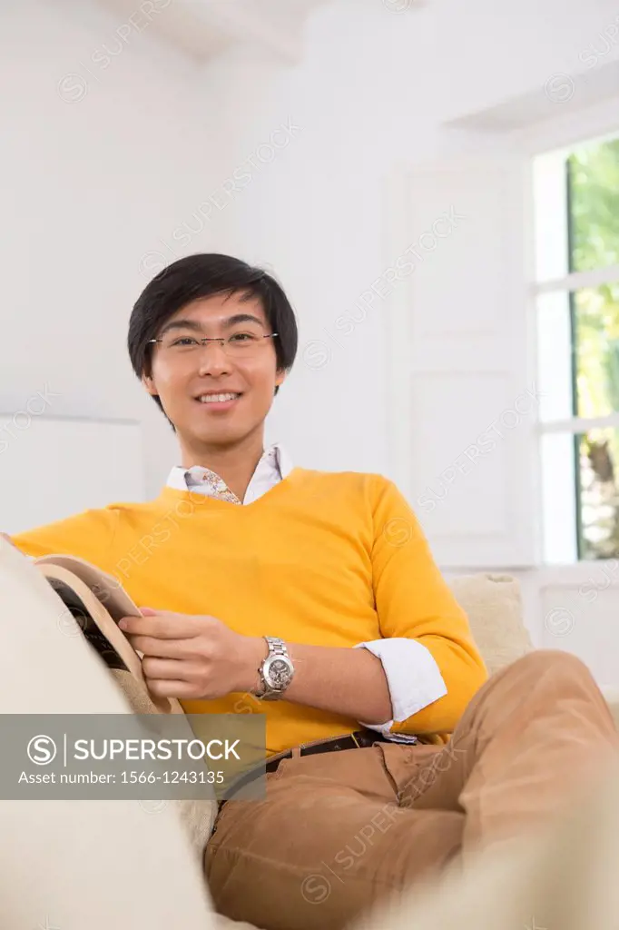 Young Asian man studying a foreign language book