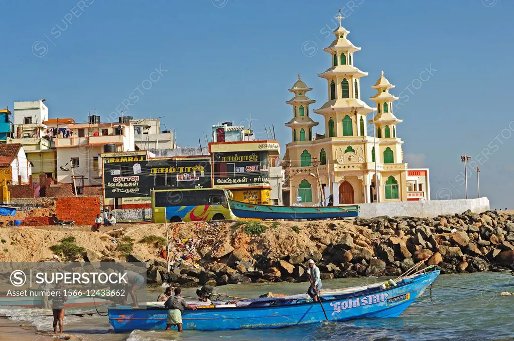 launching a fishing boat from the beach, Kanyakumari, Tamil Nadu, India.