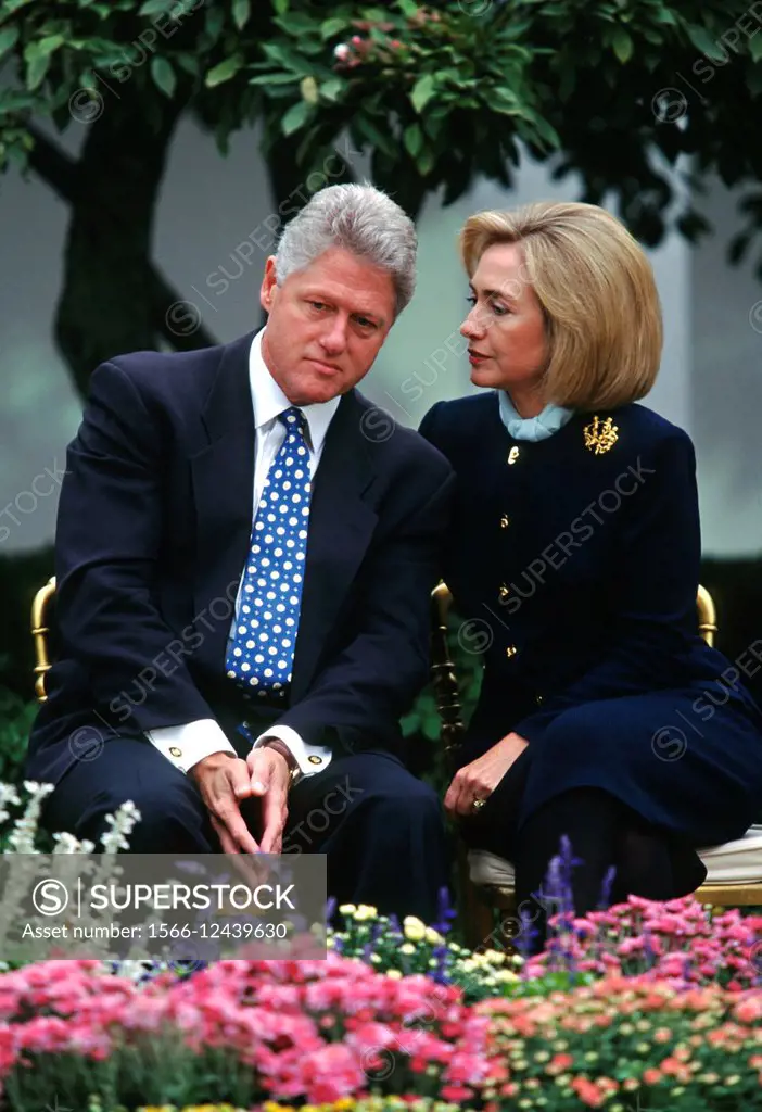 US President Bill Clinton listens to first lady Hillary Clinton during an event at the White House March 22, 1997 in Washington, DC.