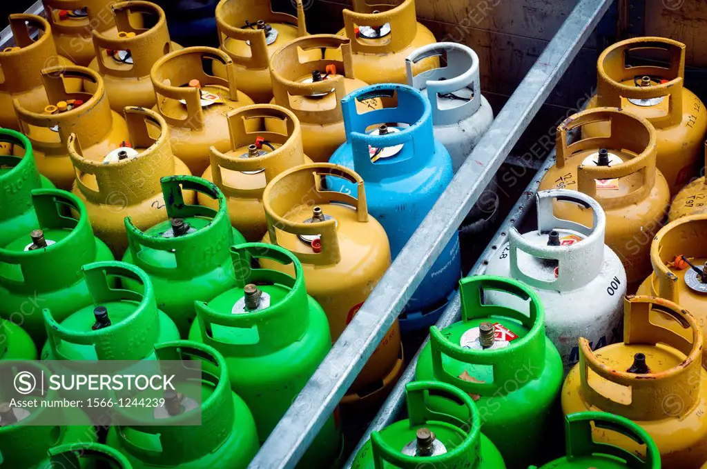 many butane gas cylinders stored in rows in a warehouse