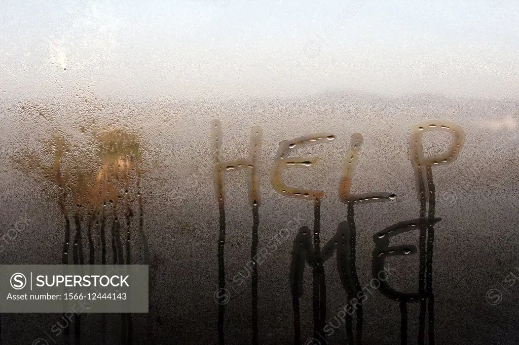 Help me words written on window with condensation in house in countryside