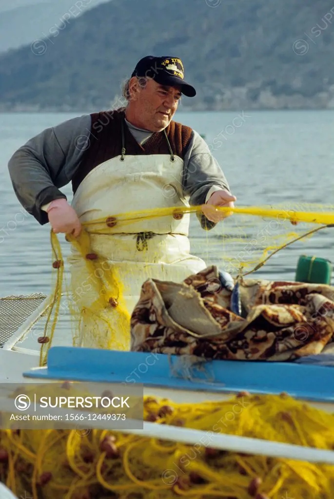 fisherman at Kilada harbour, Ermioni, Argolis, Peloponnese, Greece, Southern Europe.