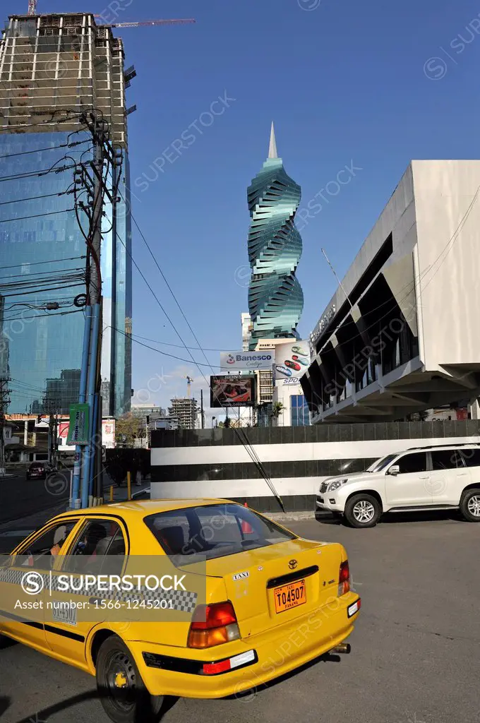 yelloh taxi with background the remarkable helical tower named Revolution Tower and also called El Tornillo, designed by Pinzon Lozano, Panama City, R...
