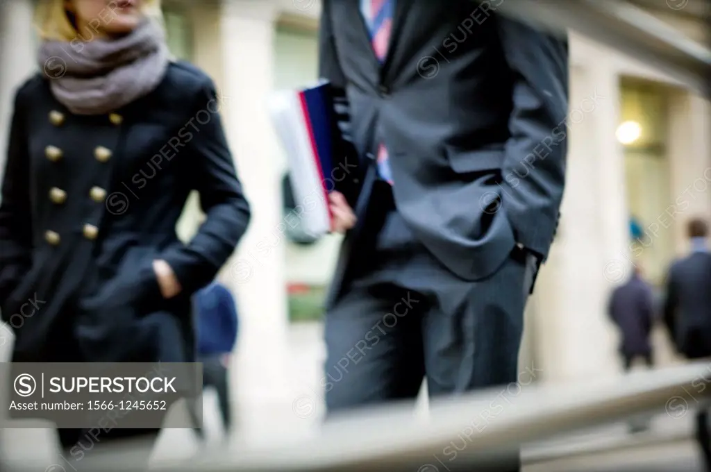 two executives walking down the street in the City of London, England, UK