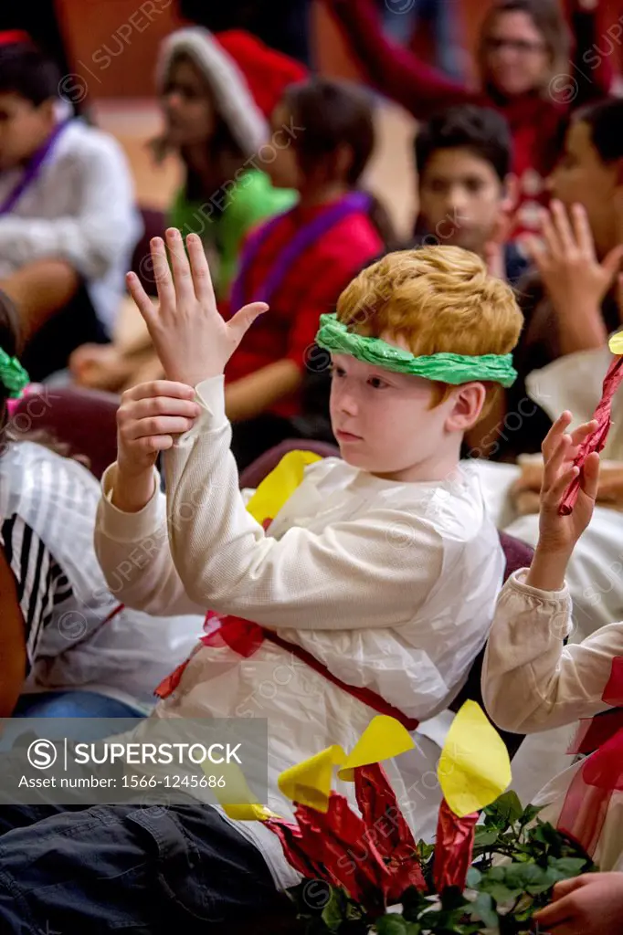 A deaf child applauds in sign language during a Christmas pageant at the California School for the Deaf in Riverside, CA