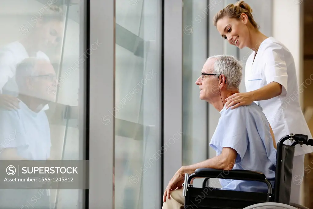 Nurse with patient in wheelchair, Corridor, Onkologikoa Hospital, Oncology Institute, Case Center for prevention, diagnosis and treatment of cancer, D...