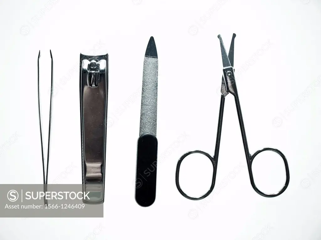 Set of metallic manicure tools: tweezers, nail trimmer, scissors, nail fail.