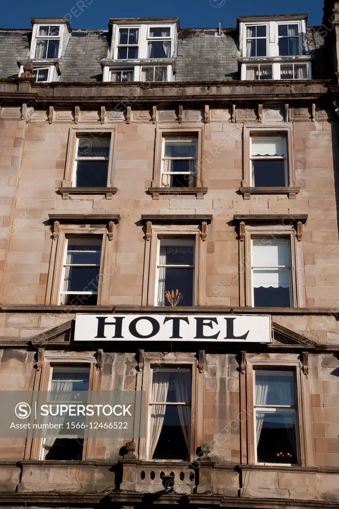 Hotel Sign on Stone Facade.