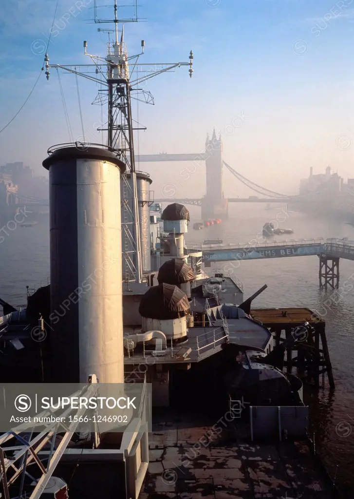 HMS Belfast on River Thames, Tower Bridge in background, City of London, England, UK