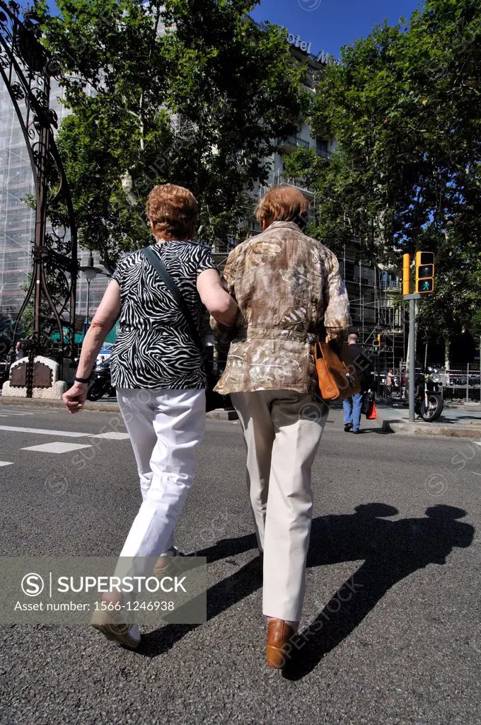 Two women walking down the street. Barcelona. Catalonia. Spain.