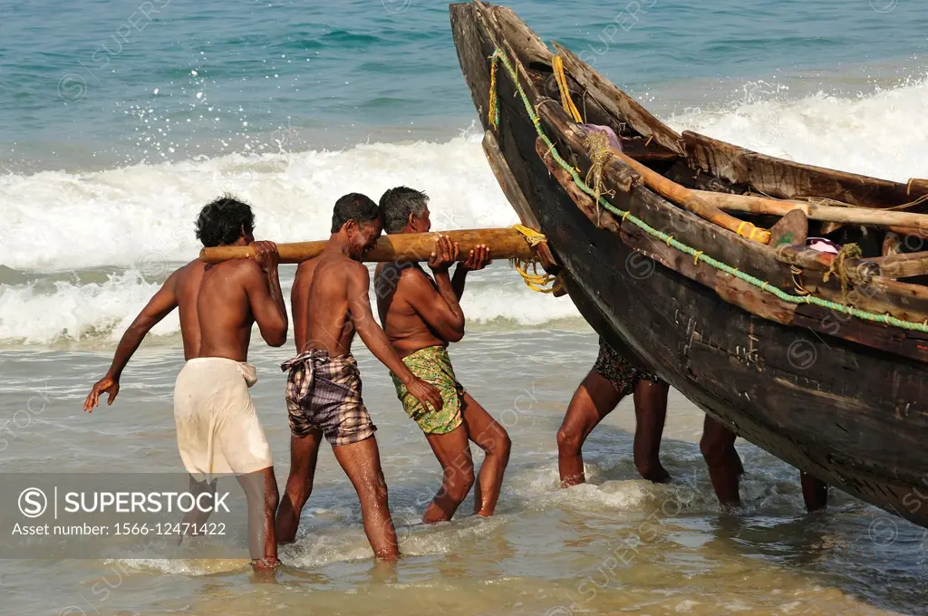 beaching a fishing boat, Hawa Beach, Kovalam, Kerala, India