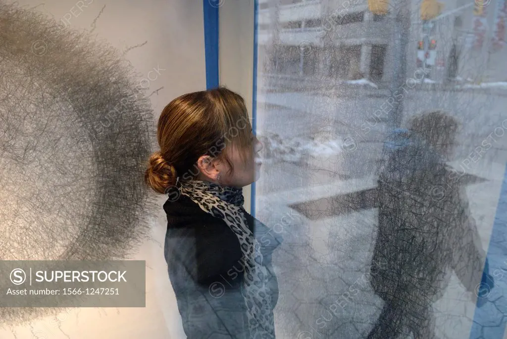 A woman artist stands in a her studio bay window. She created another in a series of ""performance paintings""-public paintings done in a repetitive m...