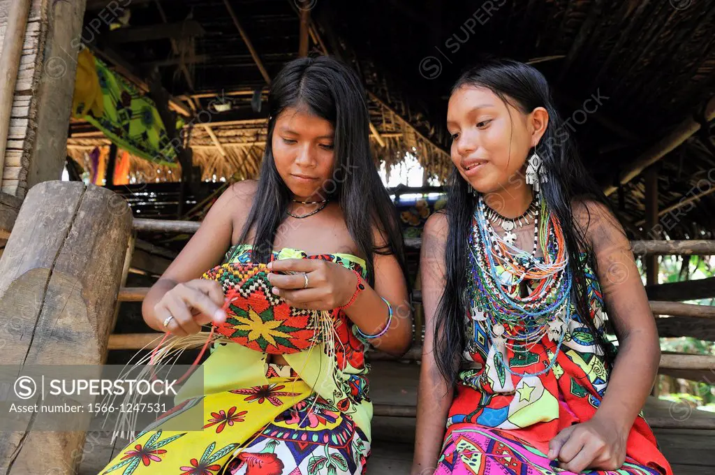 Esilda and her friends making basket, young teenagers of Embera native community living by the Chagres River within the Chagres National Park, Republi...