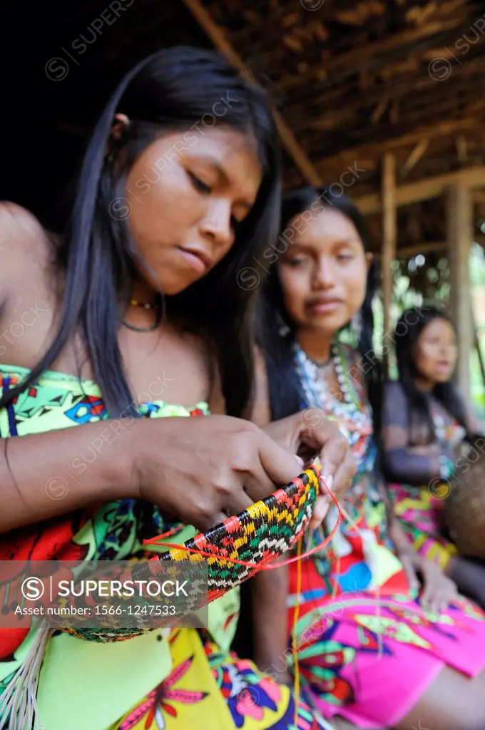 Esilda and her friends making basket, young teenagers of Embera native community living by the Chagres River within the Chagres National Park, Republi...