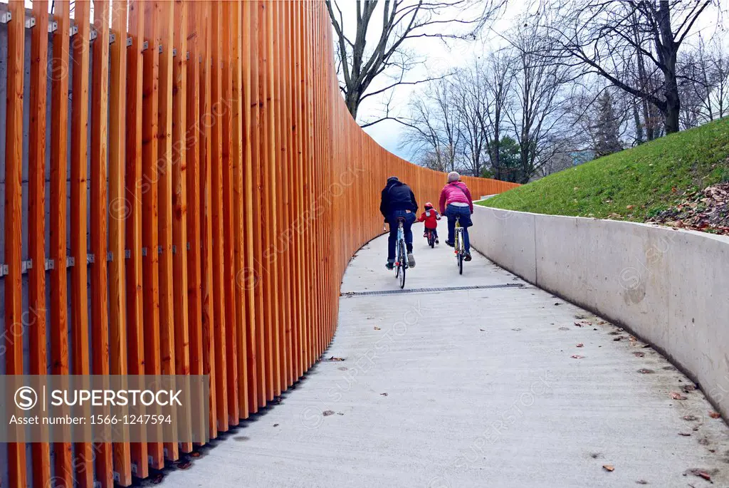 family riding bikes, pedestrian passage under the street connecting botanic garden with Geneva Lake shore, very popular road for physically active peo...