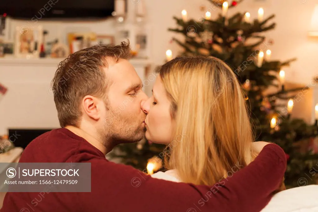 couple kissing on christmas eve.