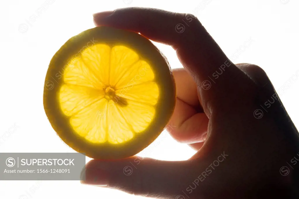 Hands holding a lemon slice