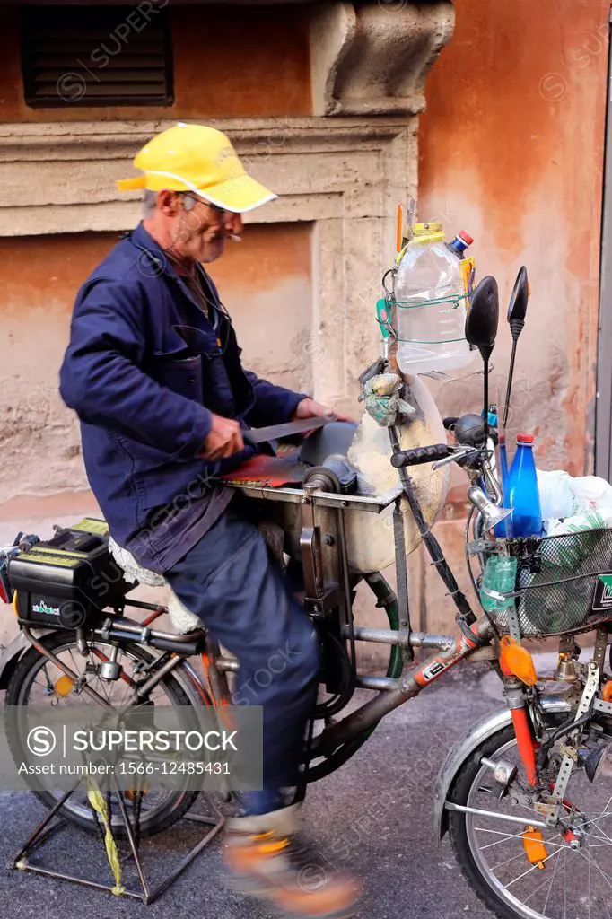 Italy. Rome. knife grinder on a bicycle.