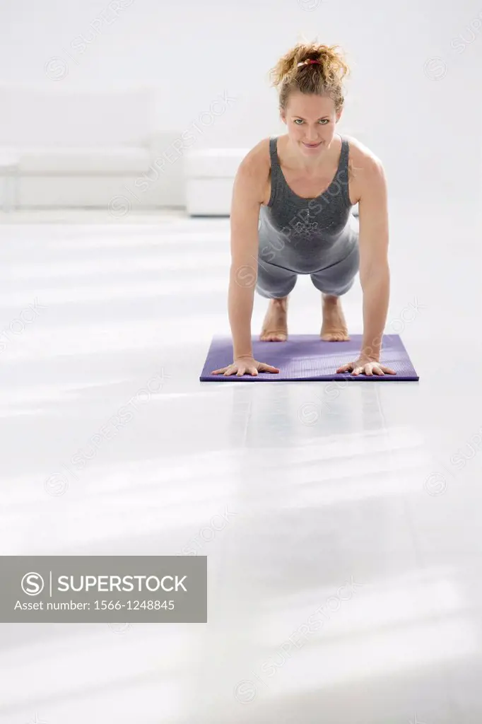 Healthy young woman doing the plank pose yoga position