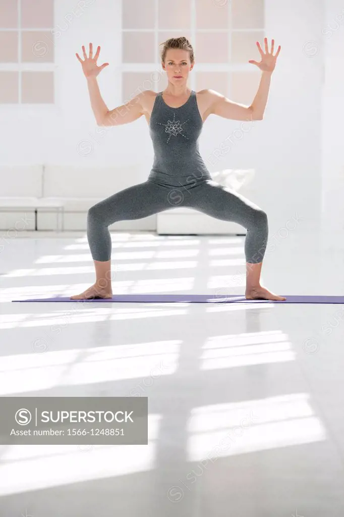 Healthy young woman in a yoga position