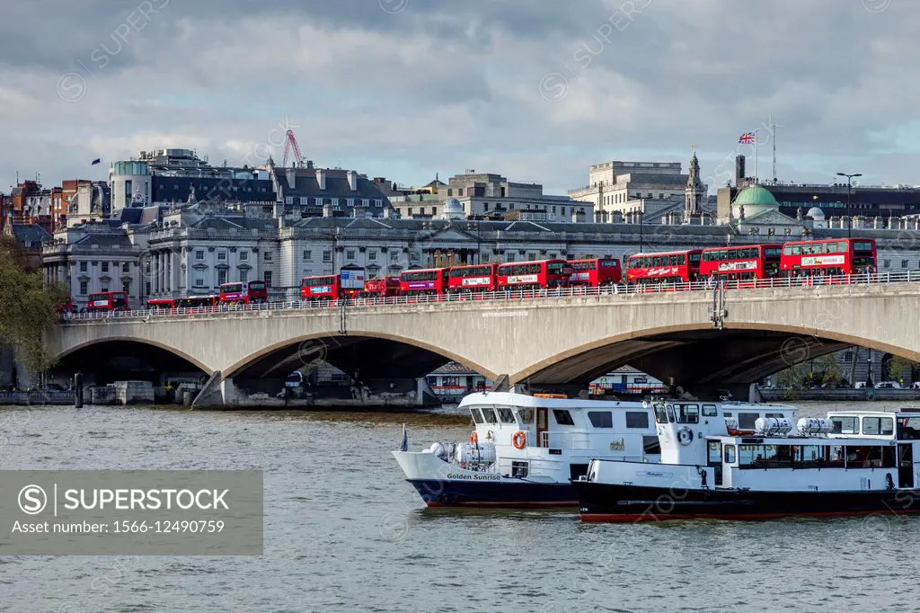 Iconic London Red Buses Crossing Waterloo Bridge, London, England.