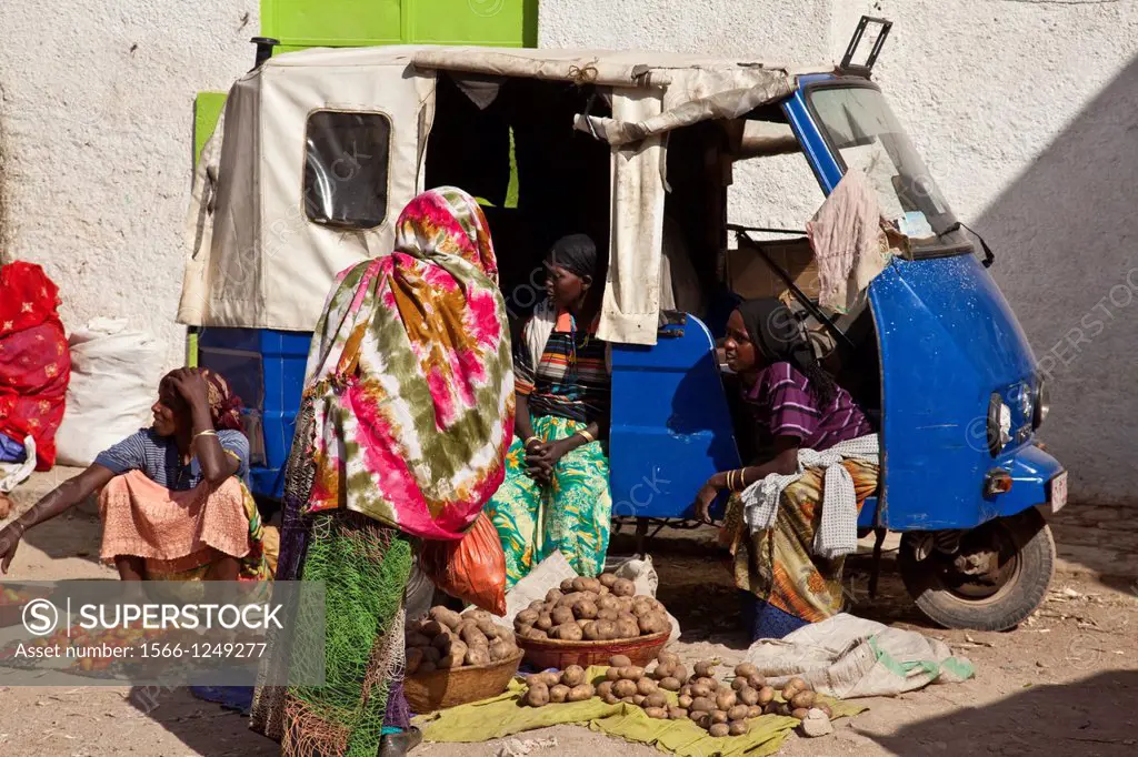 Women sit in a Tuk Tuk Taxi selling vegetables, Jugol Old Town, Harar, Ethiopia