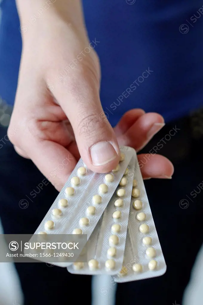 Woman holds contraceptive pills