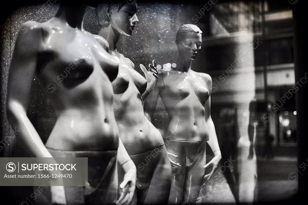 naked female mannequins in a shop window