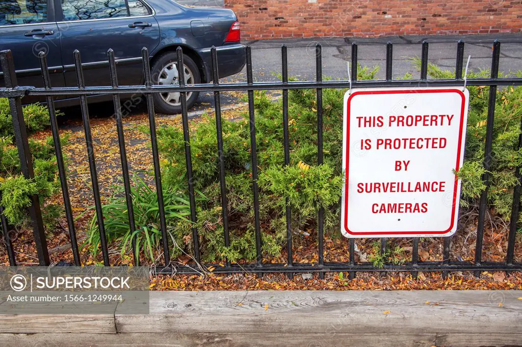 Sign by a parking lot reading, ´This property is protected by surveillance cameras´