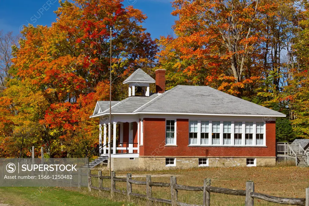 The historic Standard School, at Five Mile Creek along Highway 119 with fall foliage color near Harbor Springs, Michigan, USA