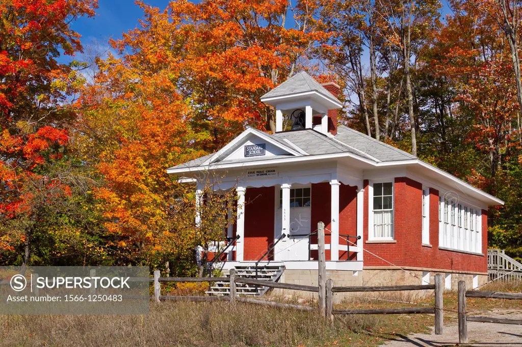 The historic Standard School, at Five Mile Creek along Highway 119 with fall foliage color near Harbor Springs, Michigan, USA