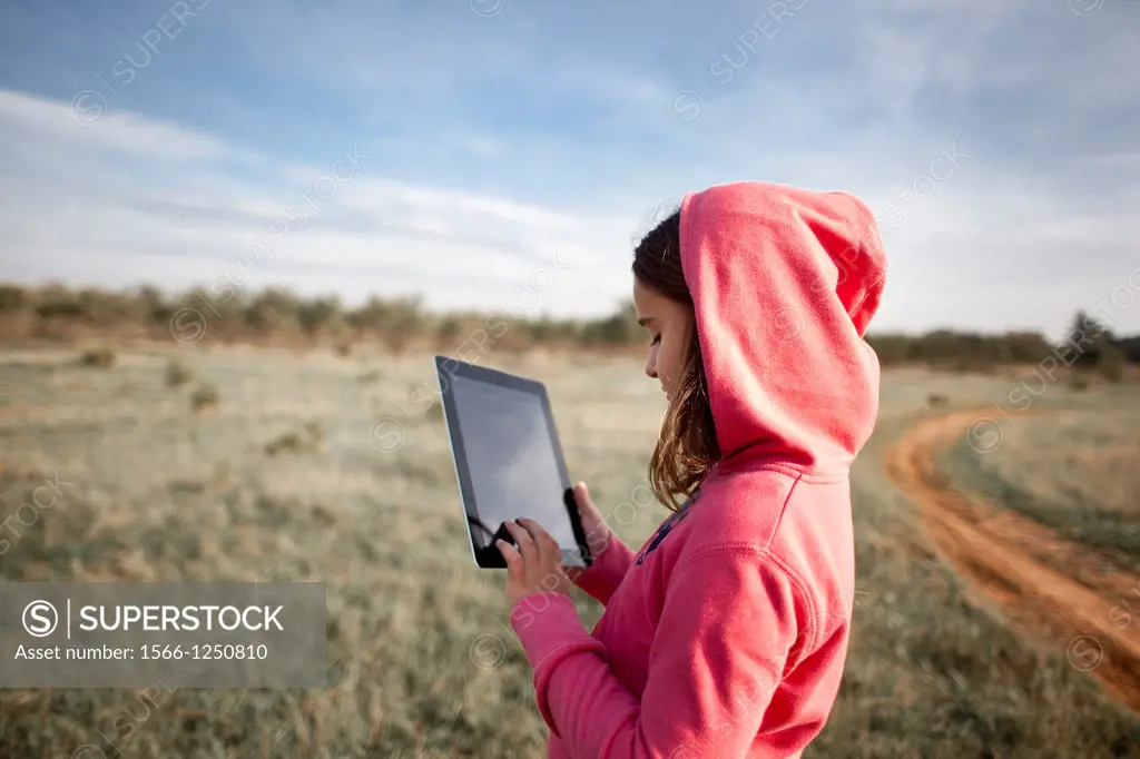 girl in the field with tablet