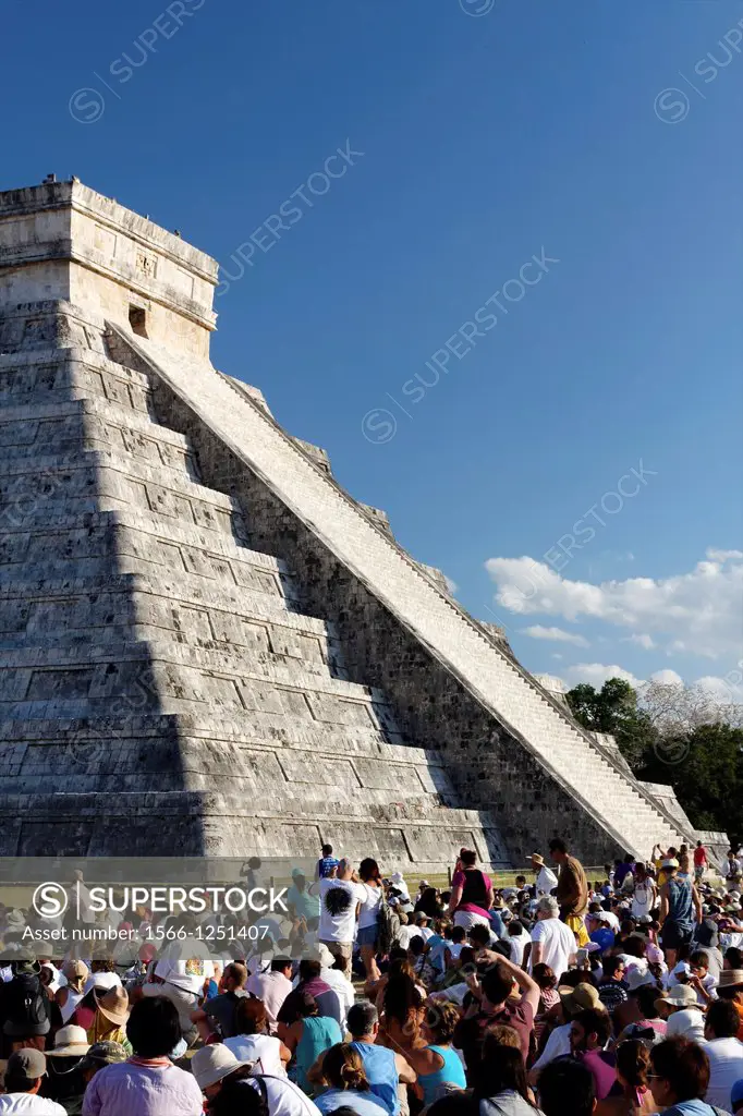 Tourists from all over the world witness the spring equinox with its famous shadowplay at the Mayan Kukulkan pyramid at Chichen Itza, Yucatan, Mexico