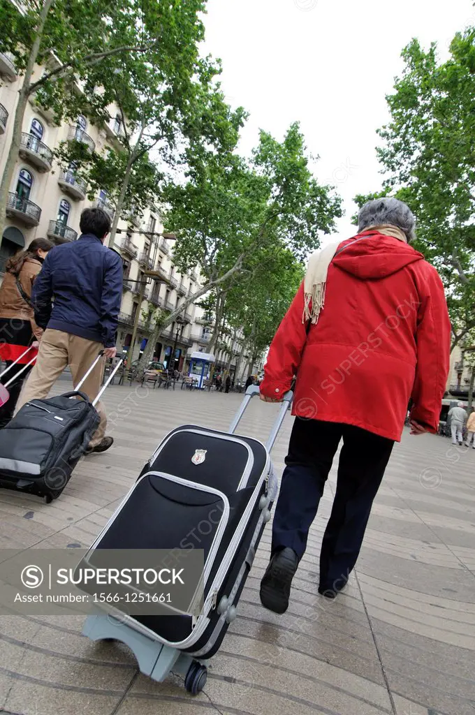 People with trolley on La Rambla Barcelona Catalonia Spain.