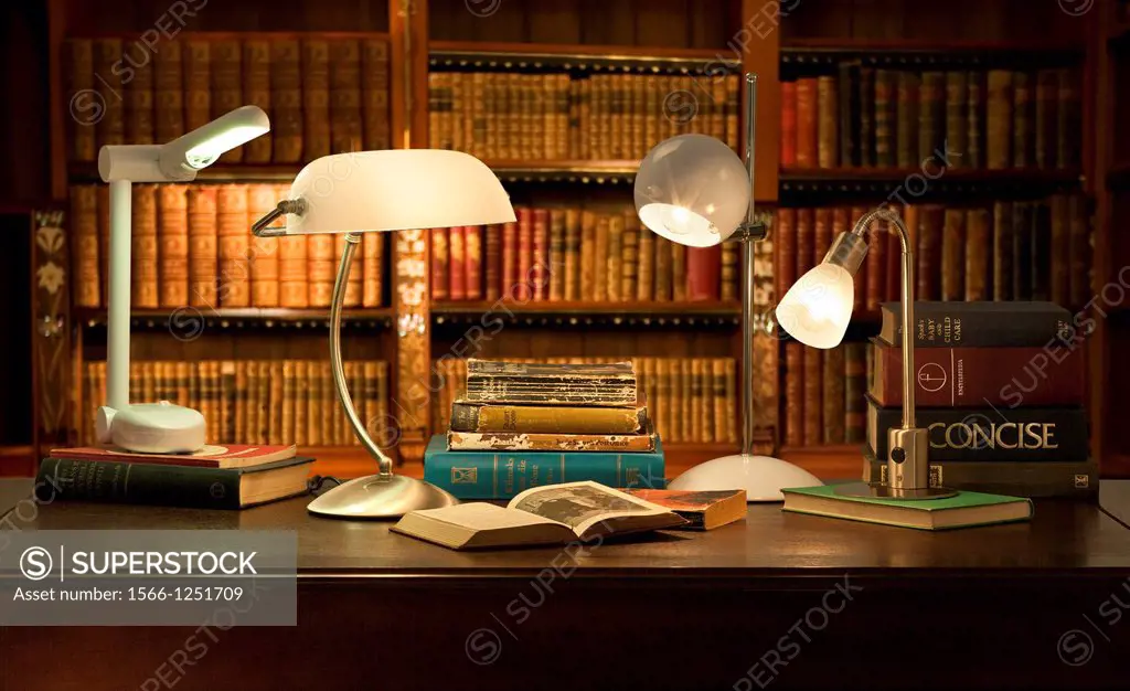 desk lamps in classic library with books in background