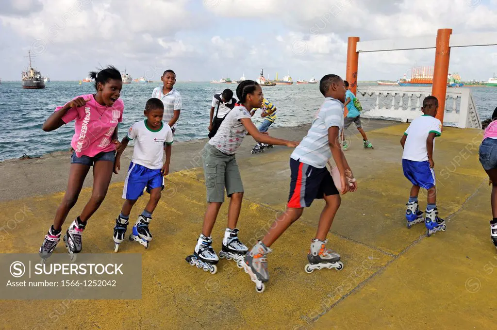 group of kids going rollerblading near the port of Colon, Republic of Panama, Central America