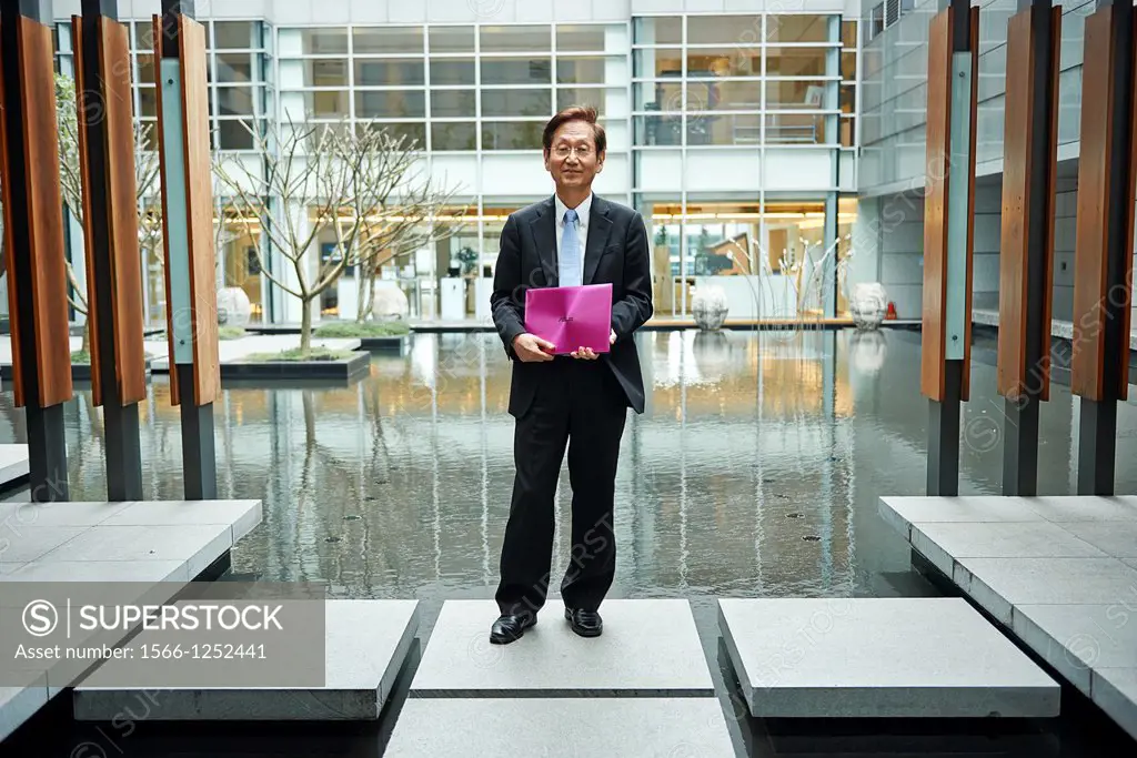 Jonney Shih, Chairman of ASUS, holding an ASUS ZENBOOK inside the Zen Garden of the ASUSTek Headquarters in Taiwan
