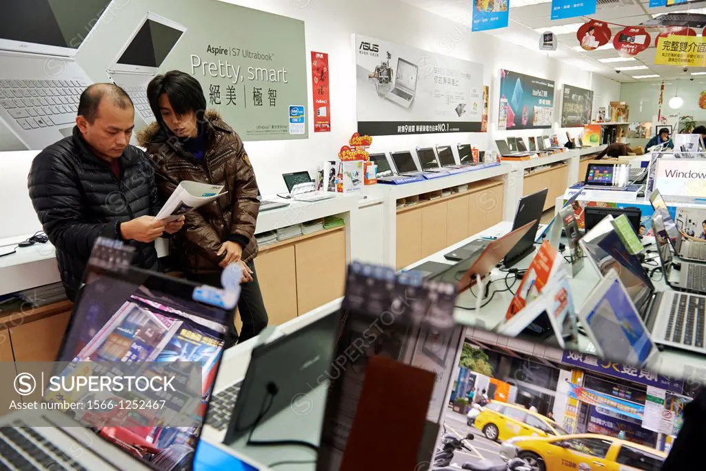Customers browse laptops inside Kun Chi Computer on Bade Road in Taipei, Taiwan
