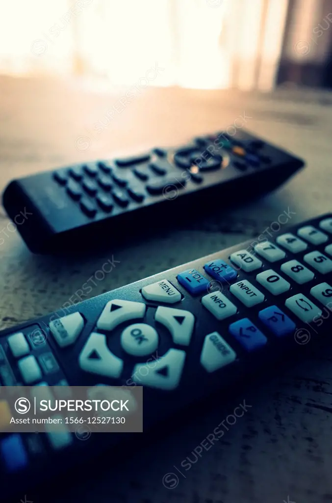 TV remotes on a table.